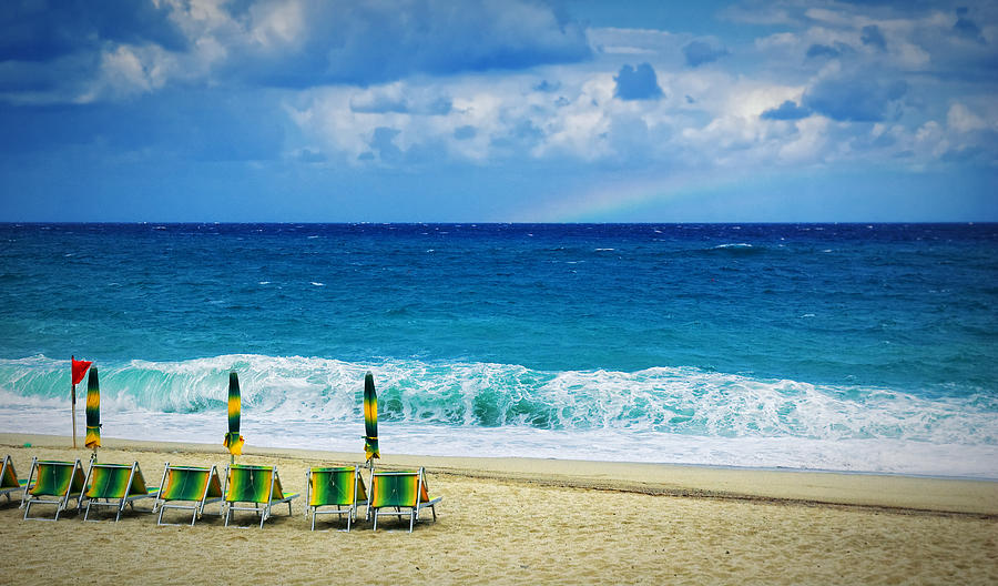 Summer Photograph - Deck chairs and distant rainbow by Silvia Ganora