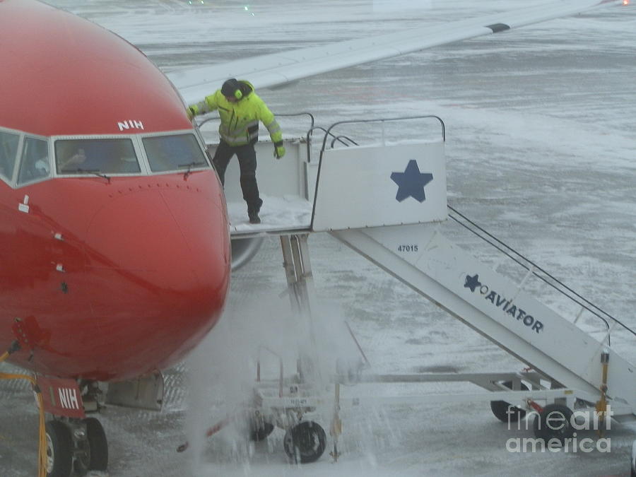 Deicing the plane Photograph by Margaret Brooks