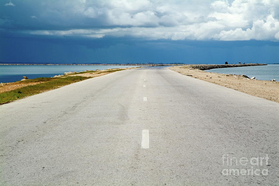 Absence Photograph - Deserted rural road with the sea on either side by Sami Sarkis