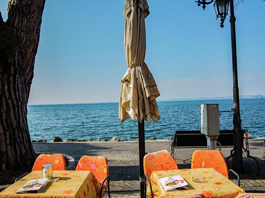 Dining on the shores of Garda Photograph by Ed James