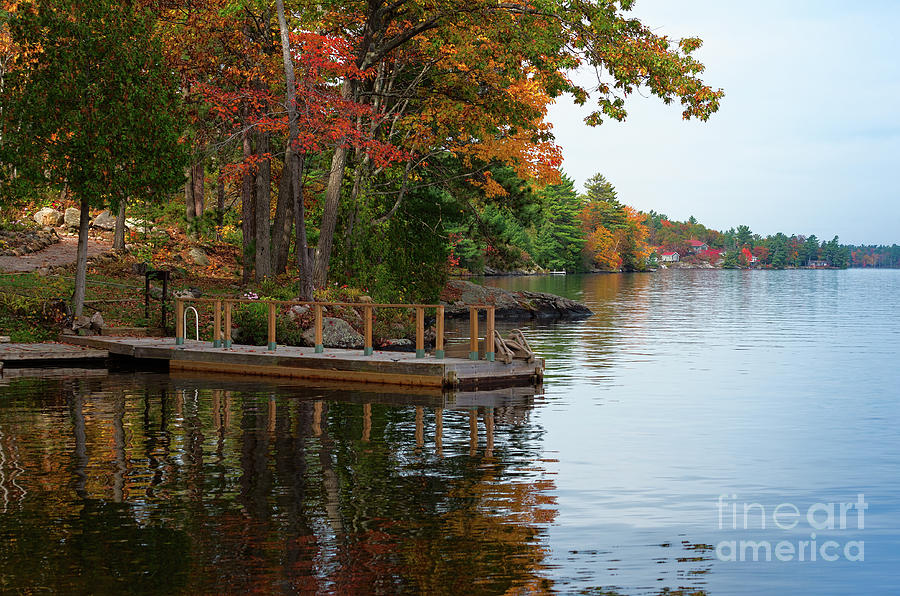 Dock on lake in fall Photograph by Les Palenik