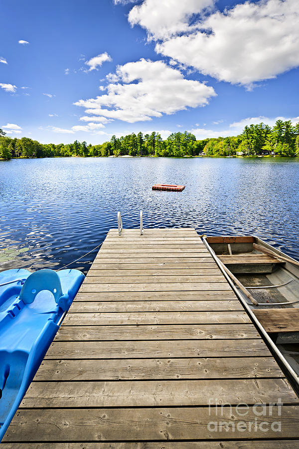 Dock on lake in summer cottage country Photograph by Elena Elisseeva