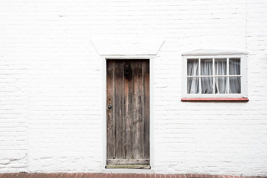 Door and window on a white wall Photograph by Michalakis Ppalis