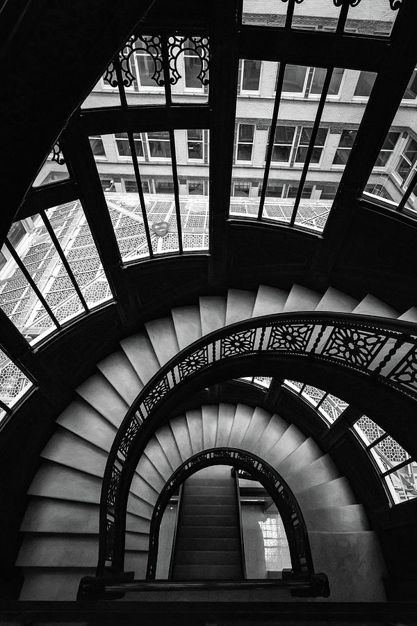Down the Rookery Building Winding Staircase And Windows in Black and White Photograph by Anthony Doudt