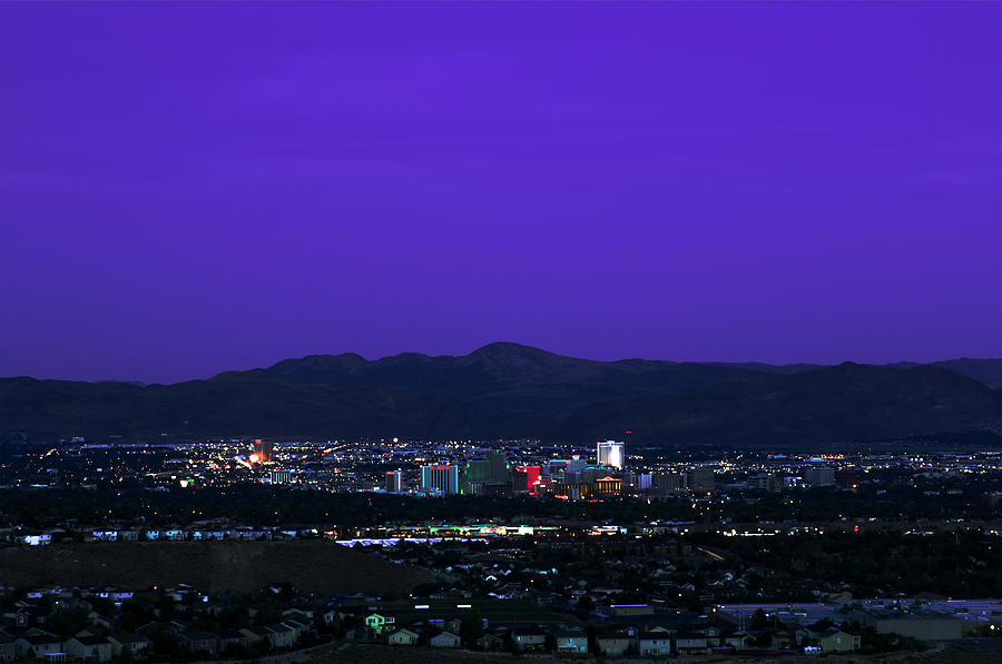 Downtown Reno, Nevada with Purple Skies over A Dark Mountain Skyline at Dusk Photograph by Brian Ball