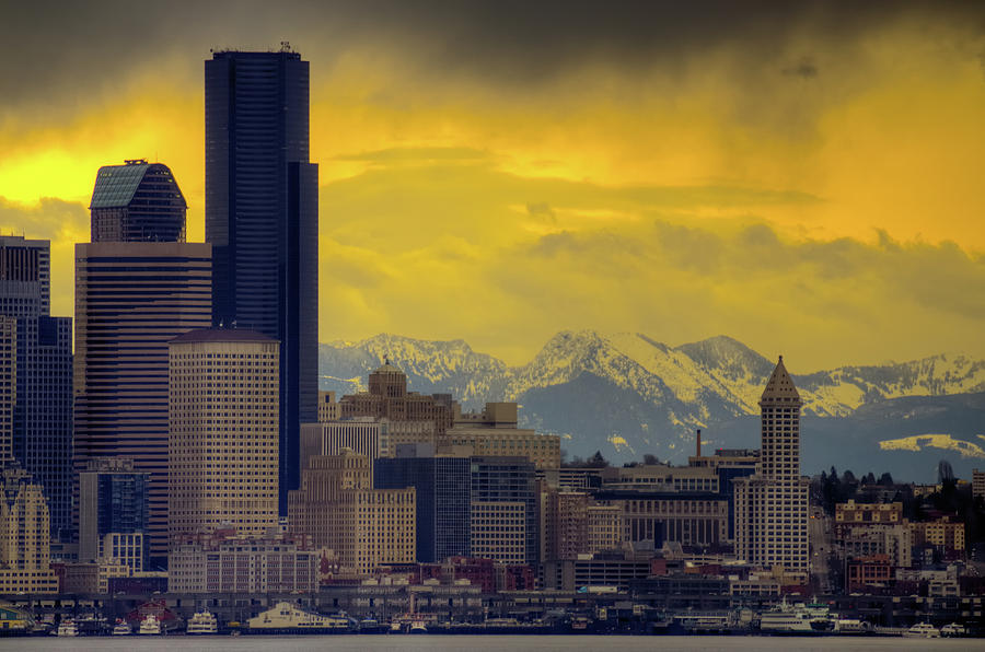 Seattle Photograph - Downtown Seattle with dramatic sky and Cascade Mountains in the  by Jay Mudaliar