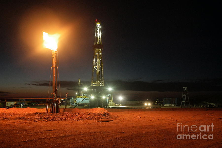 Drilling rig on a cold Dakota.Night Photograph by Jeff Swan