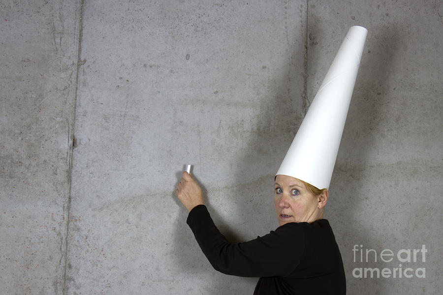 Dunce Photograph - Dunce Cap on Woman Writing on Wall by Karen Foley