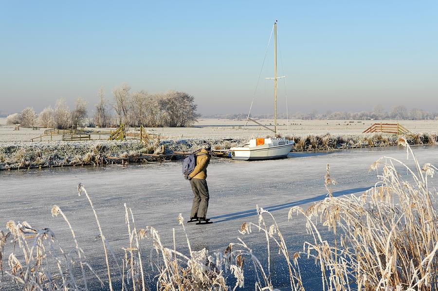 Dutch winter landscape with ice-skater Photograph by Merijn Van der Vliet