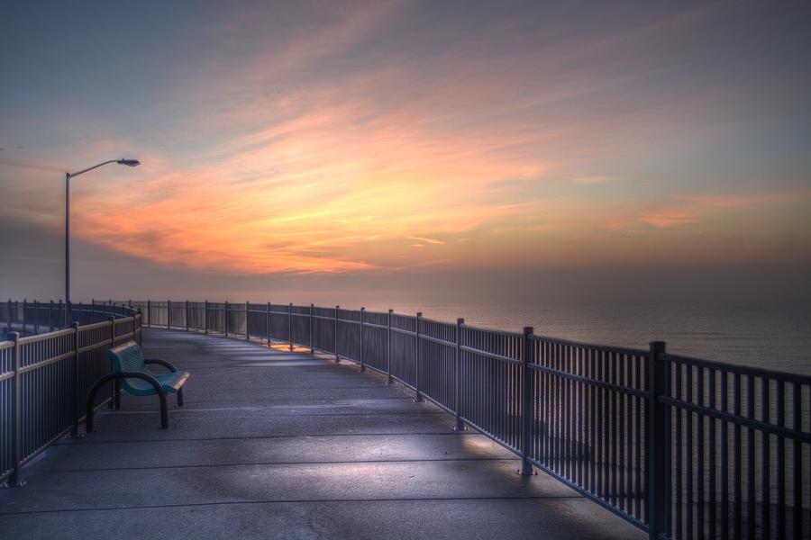 Early morning walk on Luna Pier. Photograph by Mike Guhl - Fine Art America