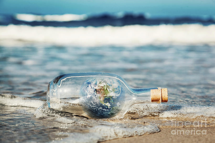 Earth in the bottle coming with wave from ocean. Environment, clean world message Photograph by Michal Bednarek