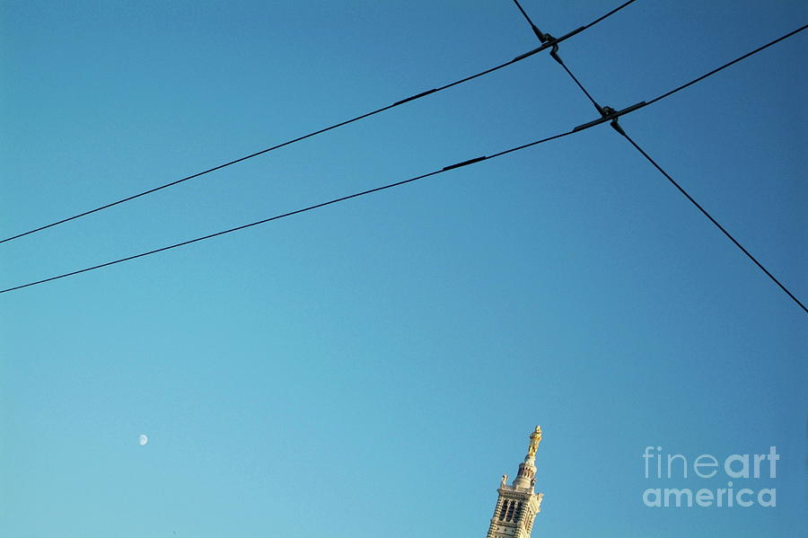 Electrical wires cross in the sky with the tip of Notre Dame de la Garde in Marseille Photograph by Sami Sarkis