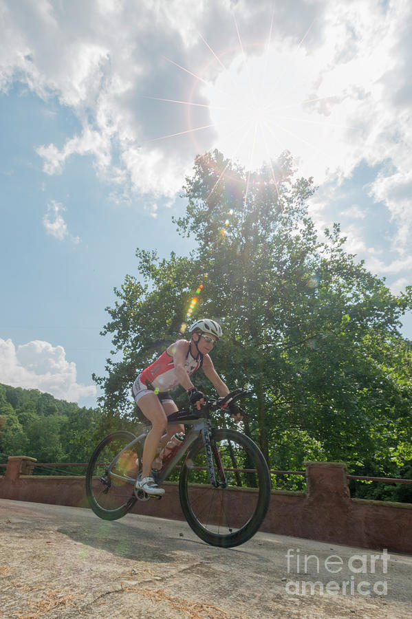 Eleonore cycling in sunburst Photograph by Dan Friend