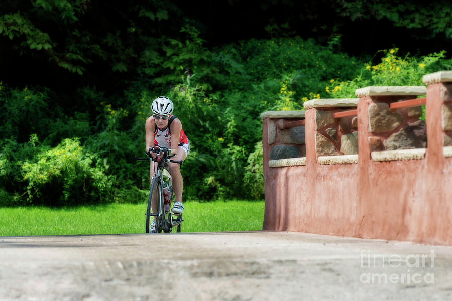 Eleonore cycling on a bridge Photograph by Dan Friend