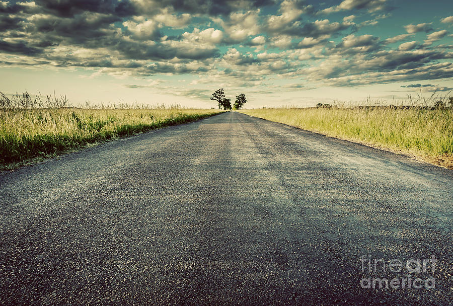 Empty straight long asphalt road. Concepts of travel, adventure, destination, transport etc. Photograph by Michal Bednarek