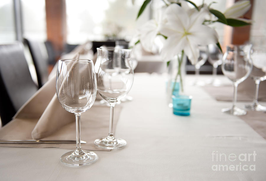 Empty wineglasses and white Lilium Lily flowers  Photograph by Arletta Cwalina