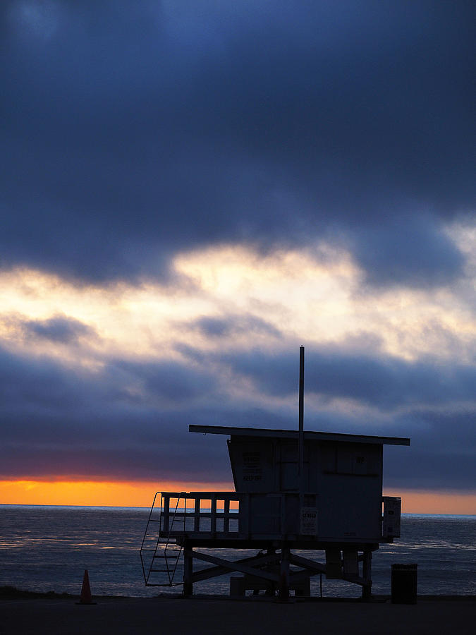 End Of Day On the Pacific. The sun sets on the Royal Palms Lifeguard shack.  Photograph by Joe Schofield