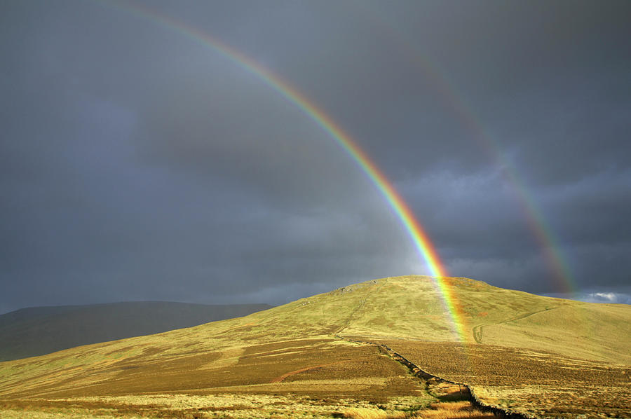 England, Northumberland, The Pennine Way. A rainbow above the Schil on ...