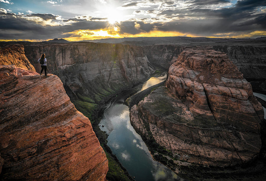 Epic image of young woman hiker overlooking Horseshoe Bend - Pag Photograph by Ryan Kelehar