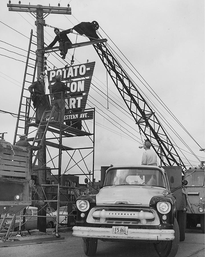 Erecting New Sign for Potato - Onion Mart  Photograph by Chicago and North Western Historical Society