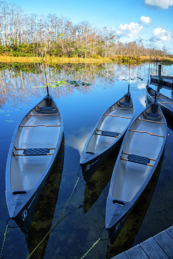 Evening Canoes at the Dock Photograph by Debra and Dave Vanderlaan