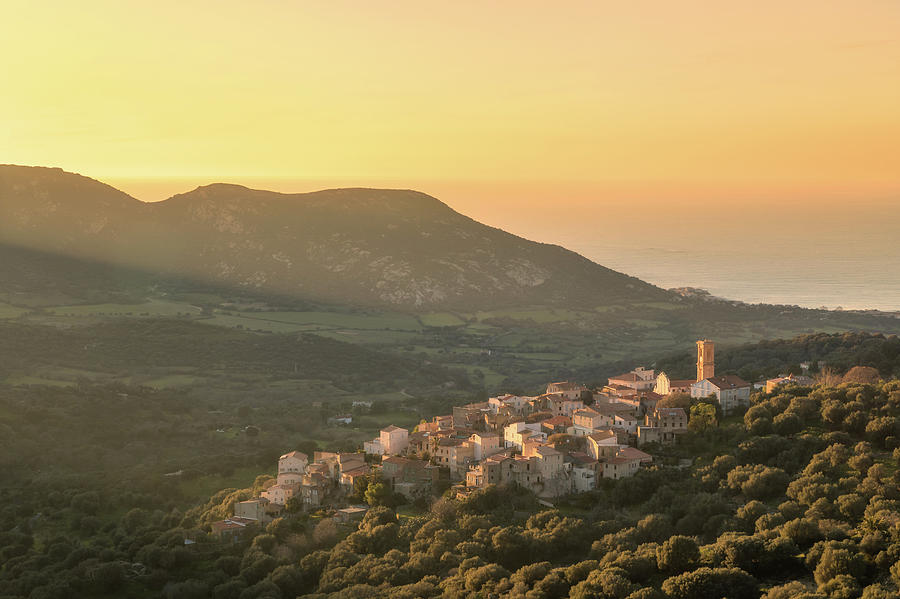 Evening sunshine on village of Aregno in Corsica Photograph by Jon Ingall