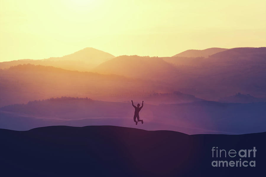 Excited man jumping of joy on a hill. Photograph by Michal Bednarek