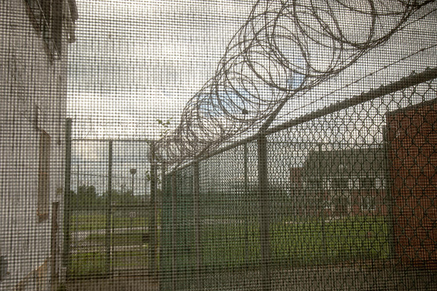 Exercise yard through window in prison Photograph by Karen Foley