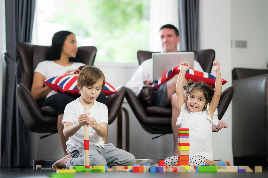 Family in living room play wooded toy Photograph by Anek Suwannaphoom