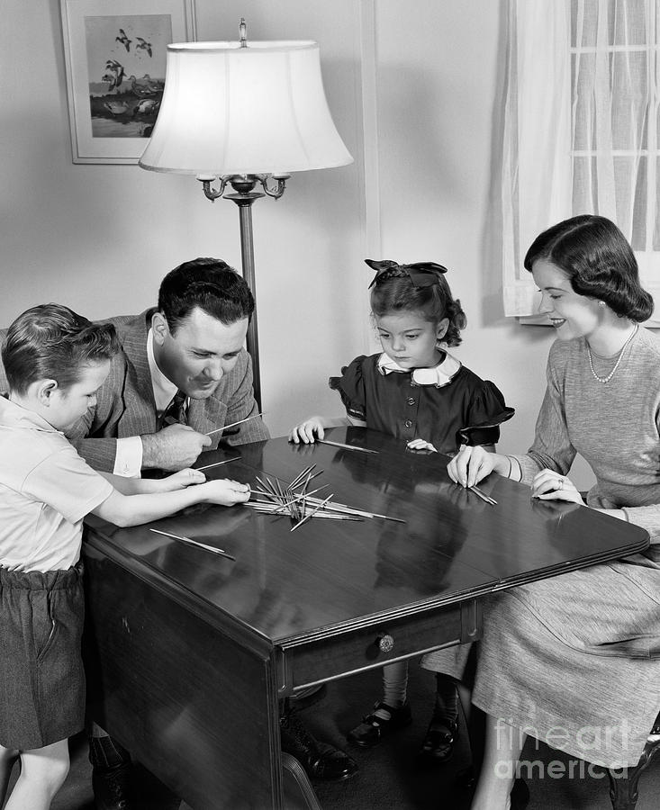 Family Playing Pick Up Sticks Photograph by H. Armstrong Roberts/ClassicStock