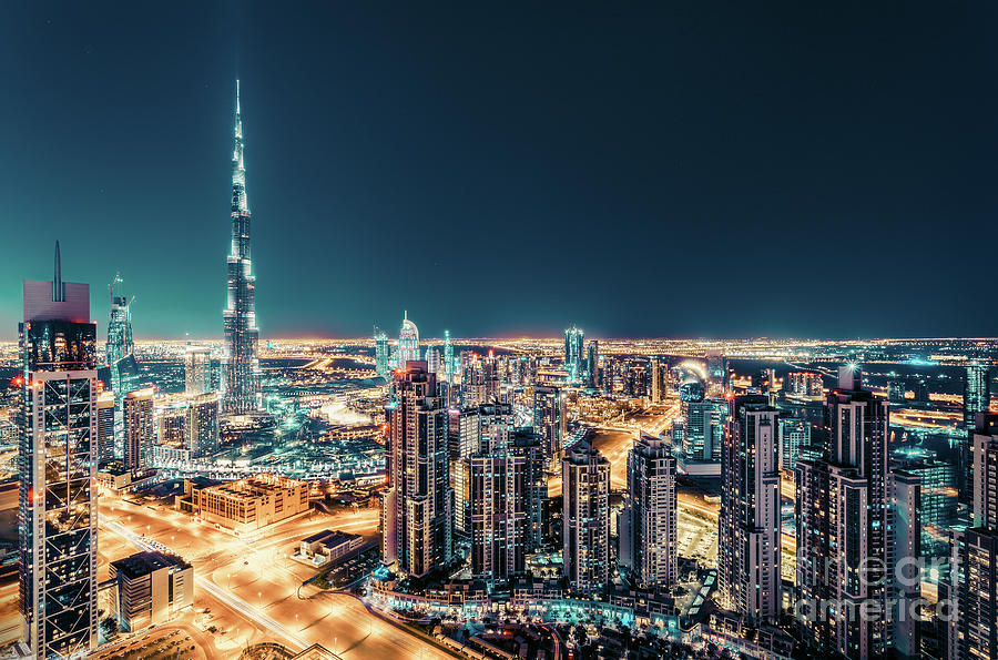 Skyscraper Photograph - Fantastic nighttime skyline of Dubai with illuminated skyscrapers. by Dmitrii Telegin