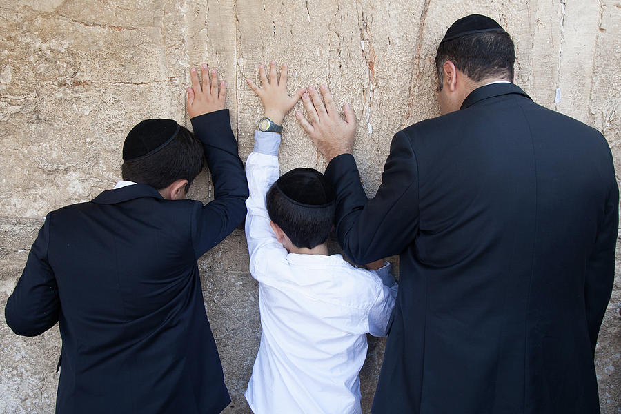 Three Hands Photograph - Father and son pray to G-d at the wailing wall by Yoel Koskas