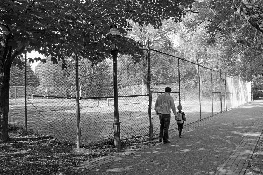 Father And Son Walking Past Tennis Courts Photograph by Cora Wandel