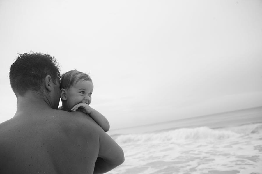 Adult Photograph - Father Holding Young Son Looking by Gillham Studios Adult Photograph - Father Holding Young Son Looking by Gillham Studios
