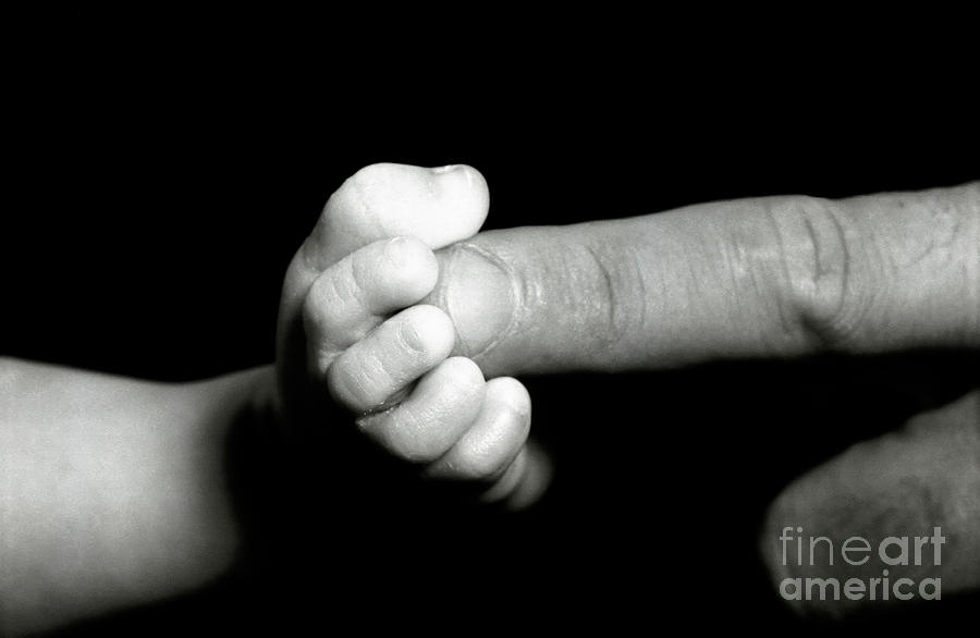 Fathers finger touching his babys foot Photograph by Sami Sarkis