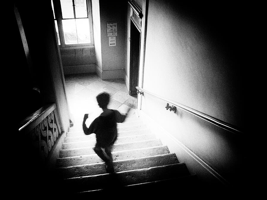 Scared boy running away Photograph by JM Ardevol