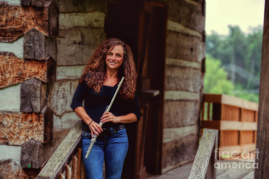 Female flute player at log cabin Photograph by Dan Friend