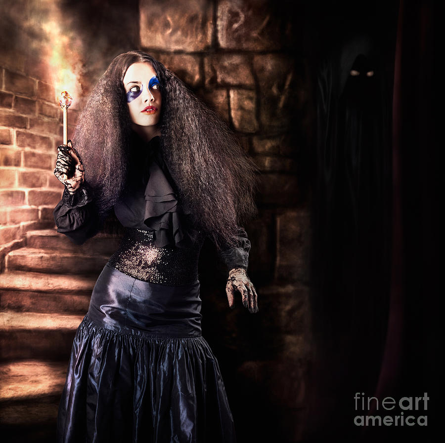 Female jester walking inside dark castle stairwell Photograph by Jorgo Photography