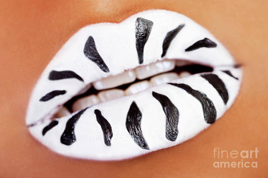 Female mouth closeup. White lipstick with black stripes