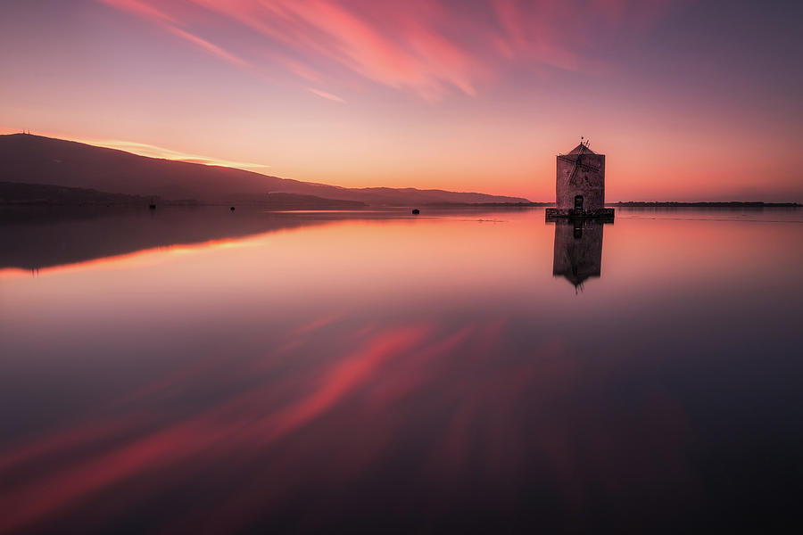 Fiery Mirror - the windmill in Orbetello reflecting itself in the mirror like water by Matteo Viviani Fiery Mirror - the windmill in Orbetello reflecting itself in the mirror like water by Matteo Viviani