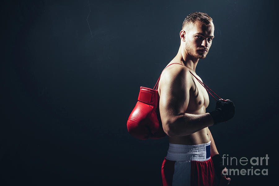 Fighter standing with gloves hanging over his back. Photograph by Michal Bednarek
