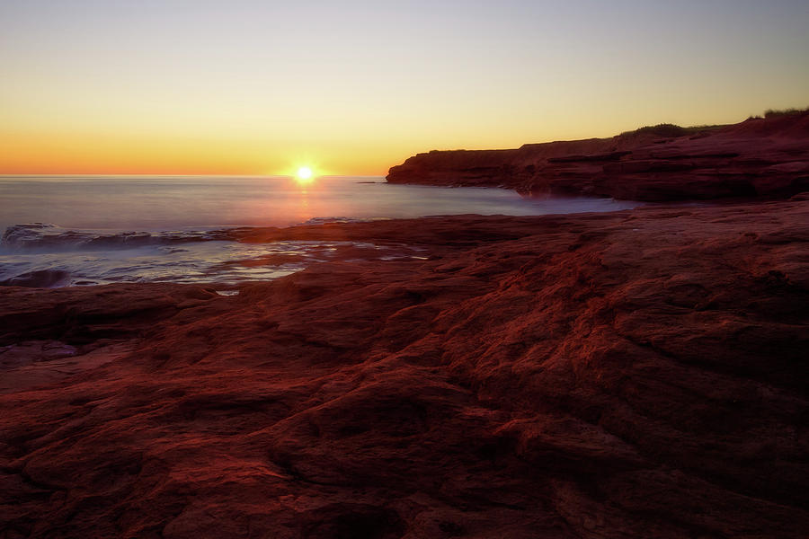 First light on Red Sandstone beach Photograph by Chris Bordeleau