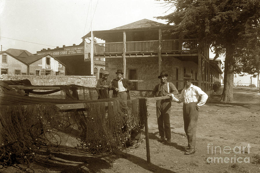 Fishermen Photograph - Fisherman drying nets in yard of the Custom House with J.K. Oliver store 1929 by Monterey County Historical Society