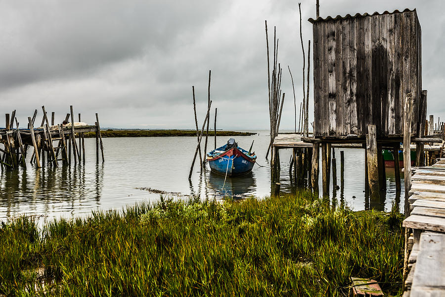 Fishing Boat And Stilt House Photograph by Marco Oliveira