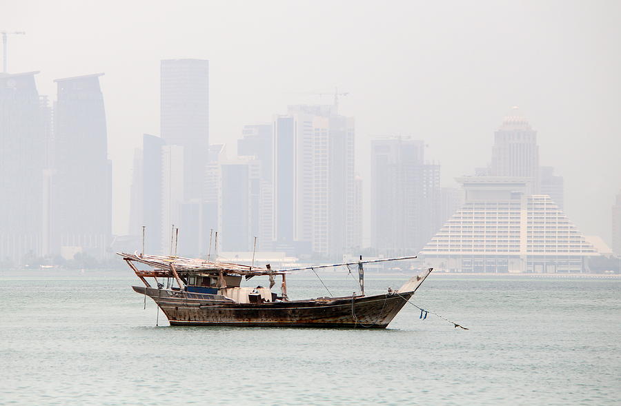 Fishing dhow and misty towers Photograph by Paul Cowan