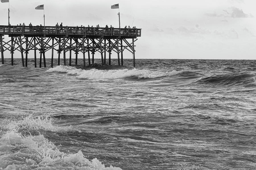 Black And White Photograph - Fishing off the pier at Myrtle Beach by Flees Photos