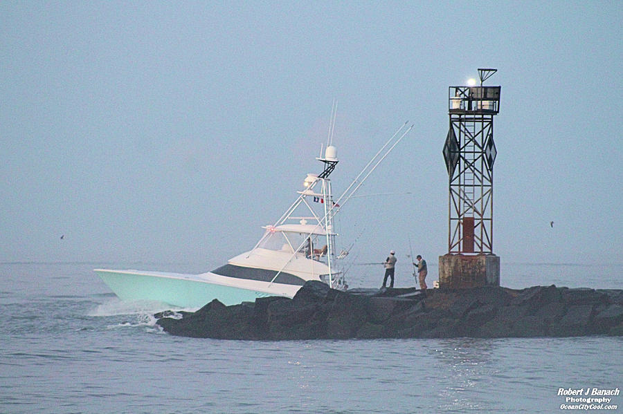 Fishing On The Inlet Jetty Photograph by Robert Banach