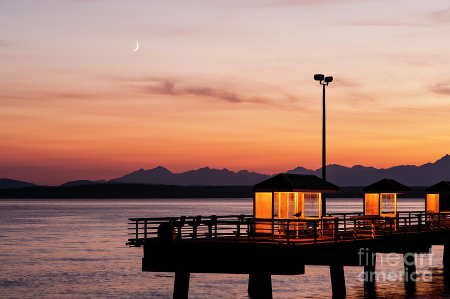 Fishing Pier on Elliott Bay with Moon and Olympic Mountains Photograph by Jim Corwin
