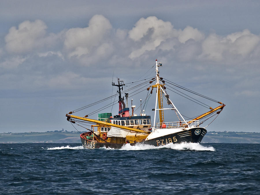 Fishing trawler heading out to sea Photograph by Gary Eason