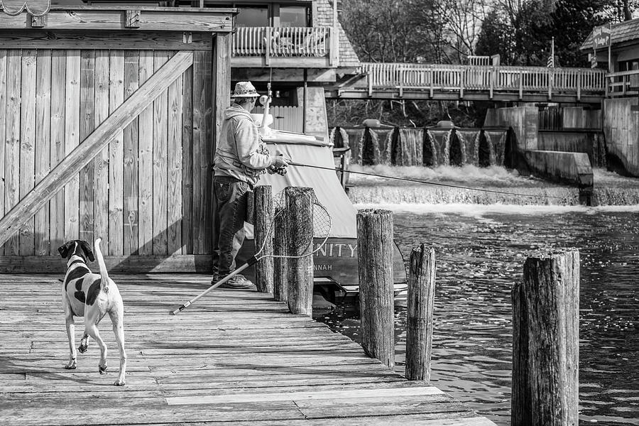Fishing with Mans best Friend Leland Michigan Photograph by John McGraw